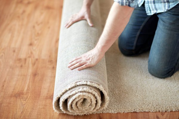 Rolling up a rug for storage