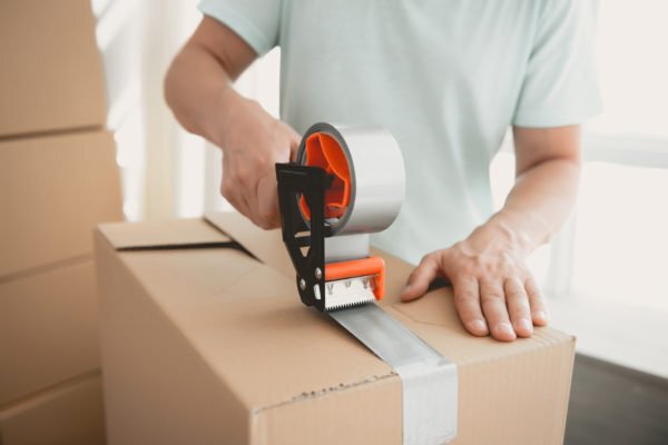 Taping a box shut for storage