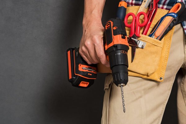 A man holding hand and power tools