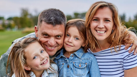 A military man smiling with his family