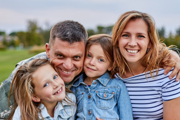 A military man smiling with his family