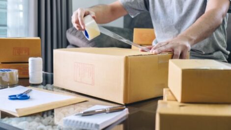 business owner taping a box shut