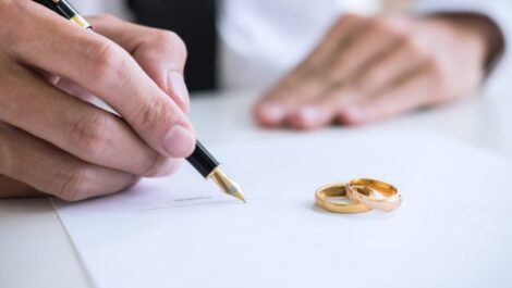 A man signing divorce papers