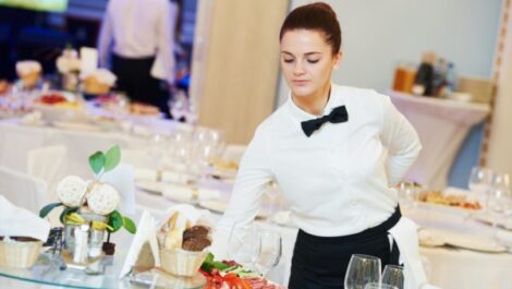 A restaurant worker with catering supplies