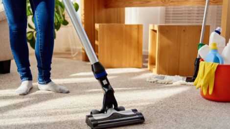 A person vacuuming their home