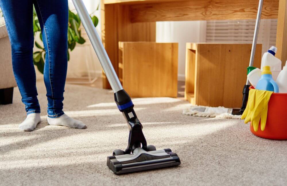 A person vacuuming their home