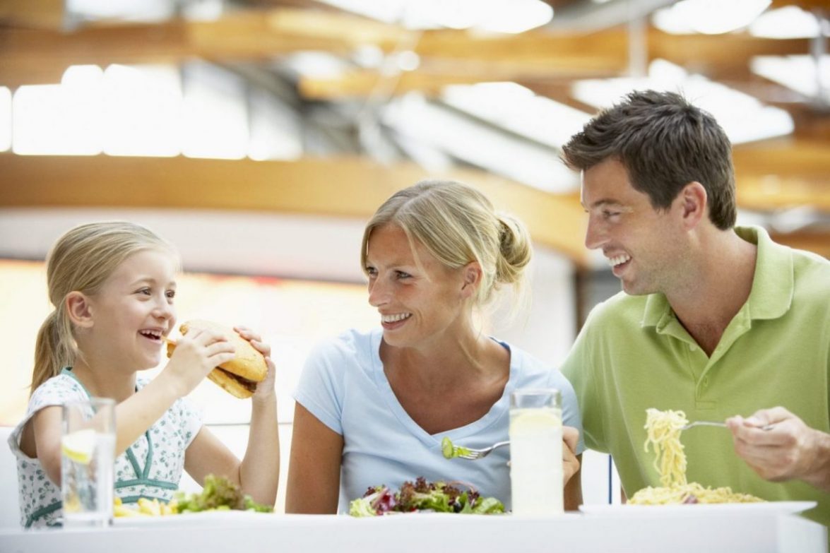 A family of three eat at a restaurant in Baltimore.