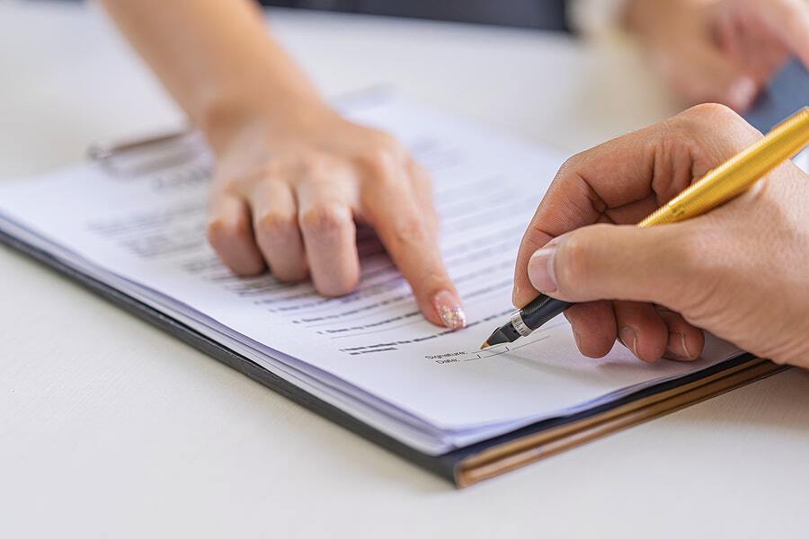 A person signs storage insurance paperwork for their new unit.