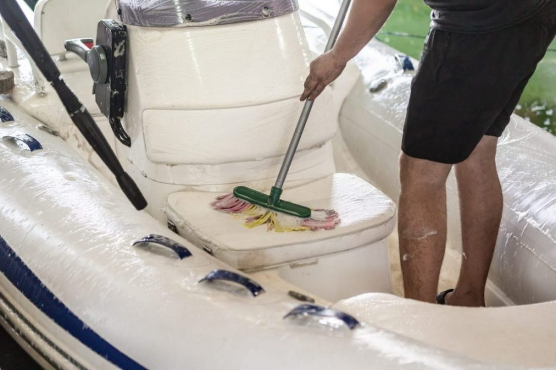 A man cleaning his boat for winter storage.