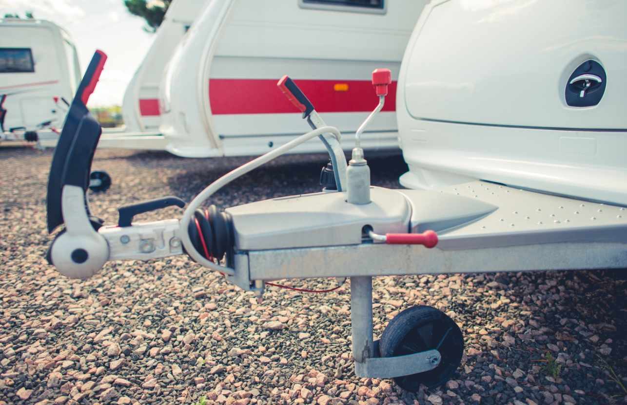 Tow hitch without an attached vehicle, stored next to other towing equipment.