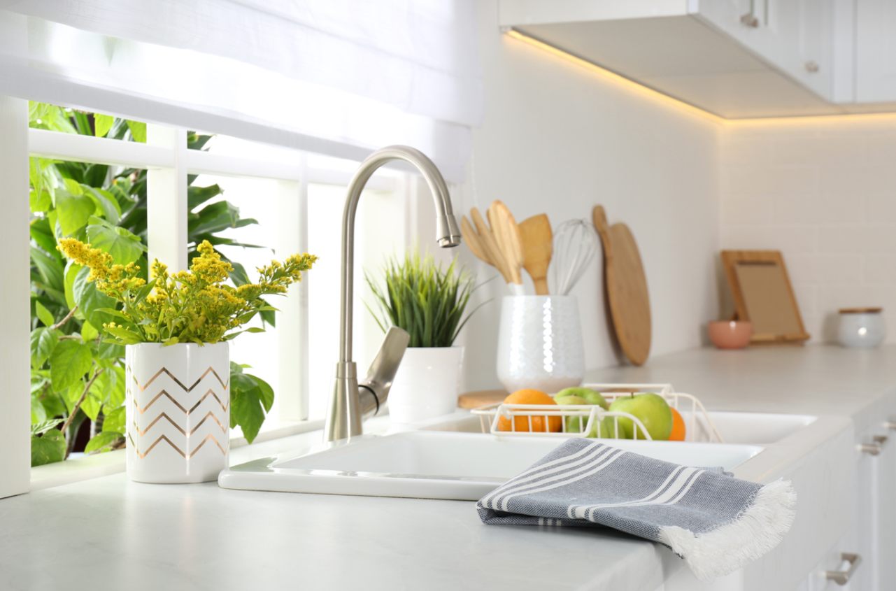 Kitchen space—including sink and kitchen utensils—with with an outdoor view.