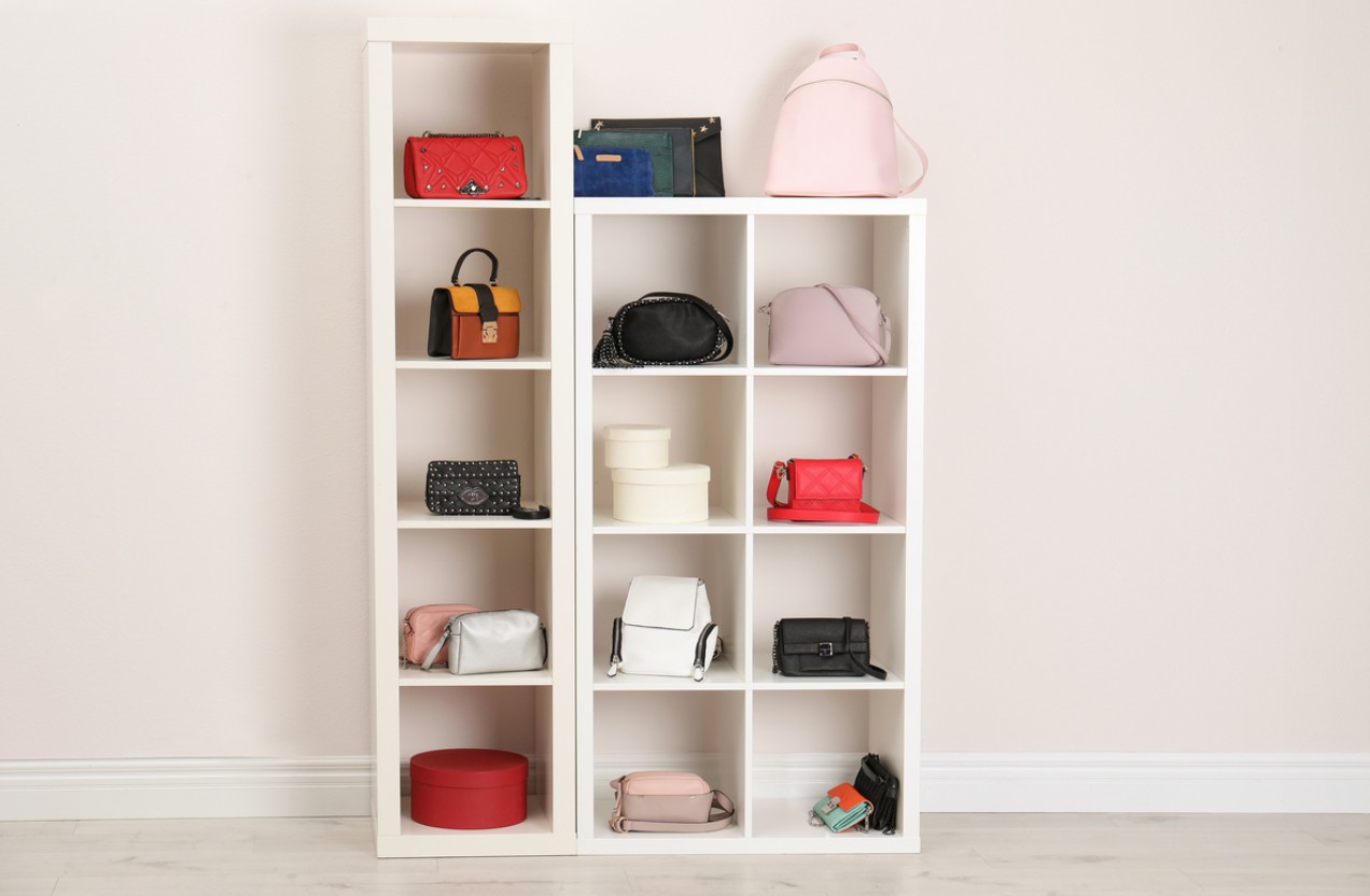 Interior living space with organized shelving furniture displaying handbags.