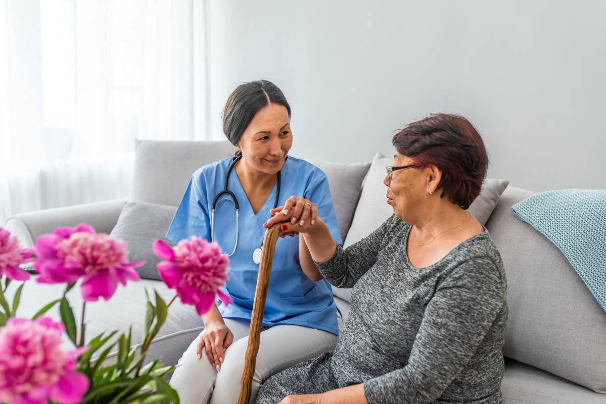 Nurse talking with a patient on a couch.