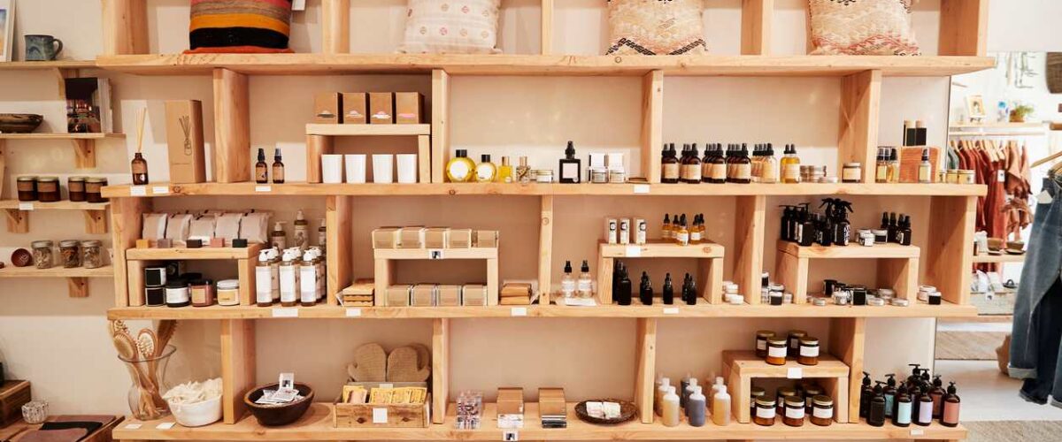 Organized product displays on shelving inside a small independent retail shop, showing seasonal inventory.