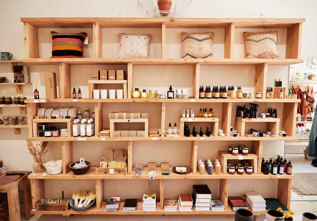 Organized product displays on shelving inside a small independent retail shop, showing seasonal inventory.